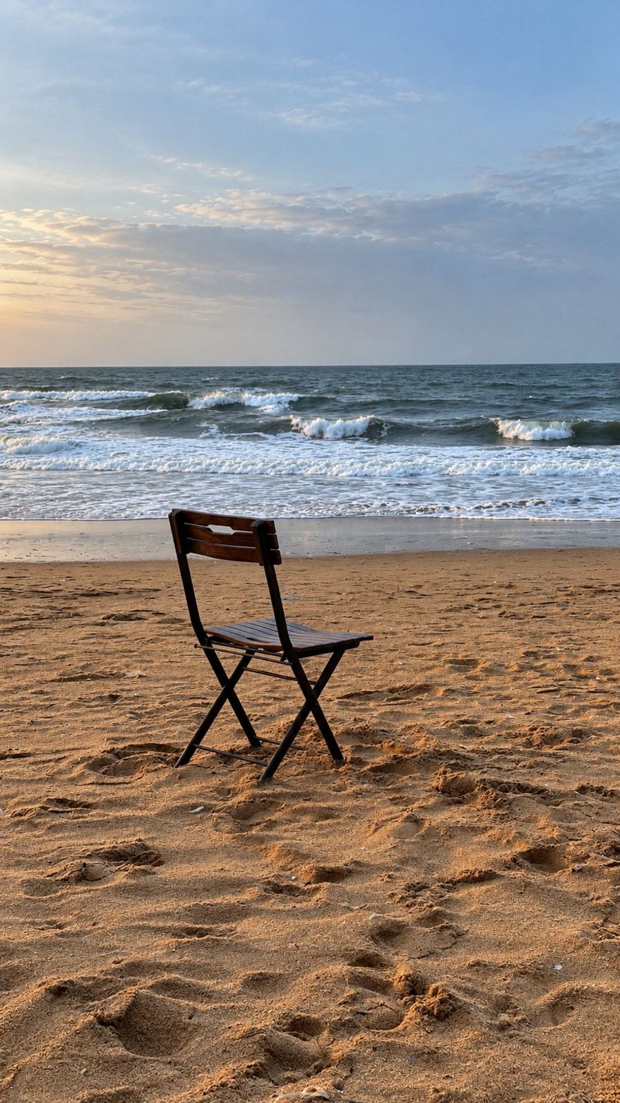 A chair on the sand at Candolim beach, Raht Aashyana Lakhanpal, Candolim, Goa